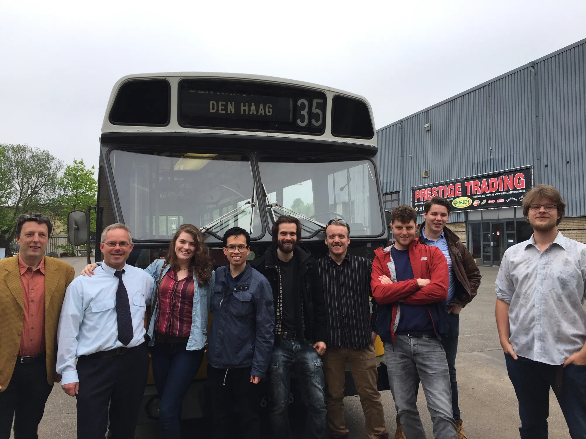 Sunny Juliette crew and cast standing in front of an old bus